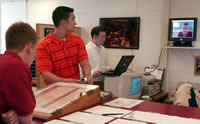 Purdue University undergraduate student Rich Skinner's facial features are scanned by the camera, which graduate student Eric Kukula (center) adjusts. 